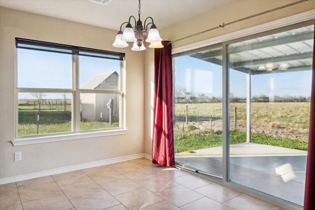 entryway featuring a notable chandelier, a rural view, and light tile patterned floors