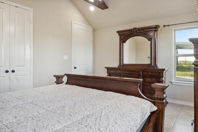 bedroom with vaulted ceiling, ceiling fan, and light tile patterned flooring