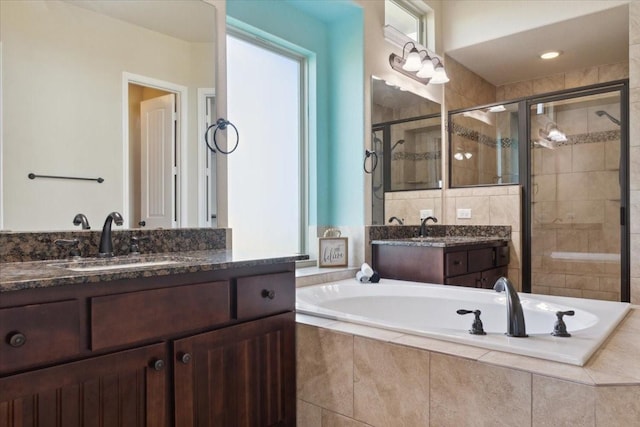 bathroom featuring plus walk in shower and vanity