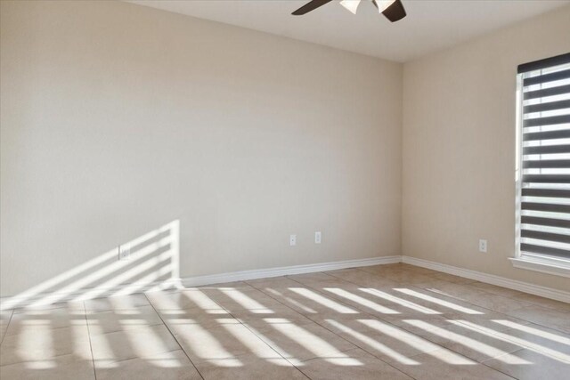 unfurnished room with ceiling fan and light tile patterned floors