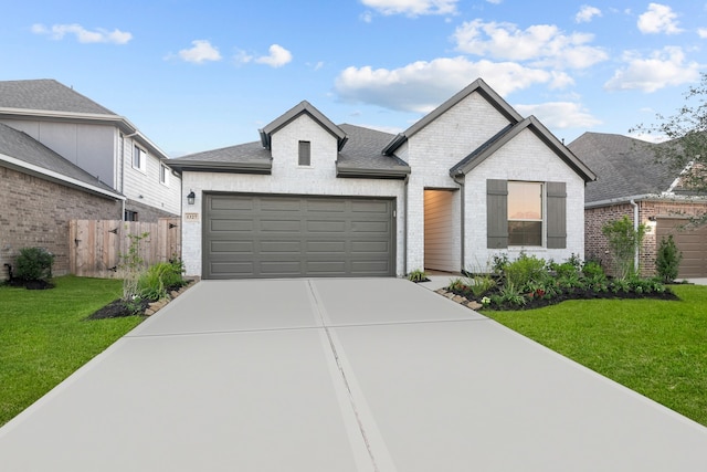 view of front of property featuring a garage and a front lawn