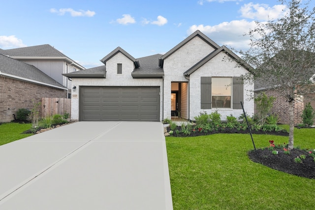 view of front of property with a front yard and a garage