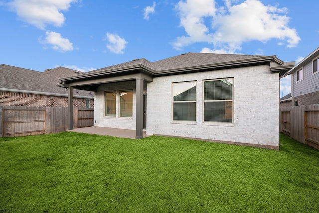 back of property featuring a lawn and a patio