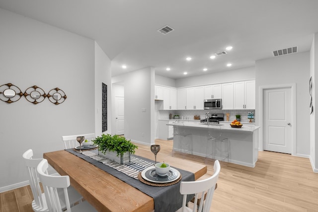 dining room with light wood-type flooring