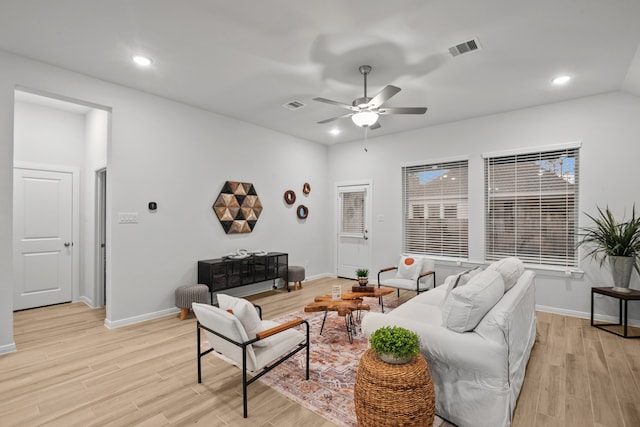 living room featuring light hardwood / wood-style floors and ceiling fan