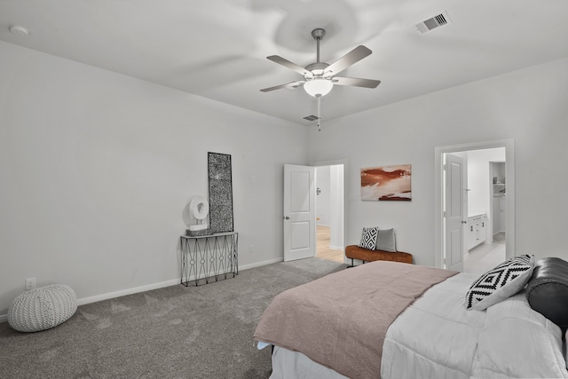 carpeted bedroom featuring ensuite bath and ceiling fan