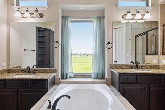 bathroom with vanity and independent shower and bath