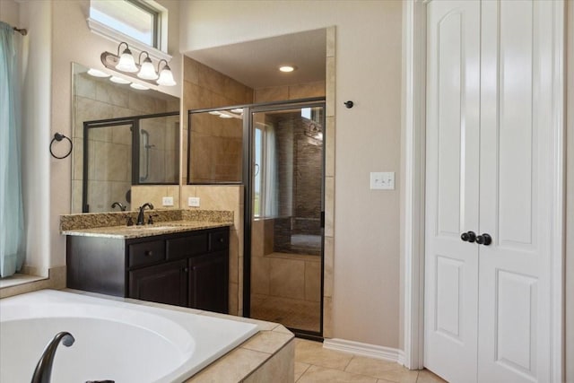 bathroom featuring plus walk in shower, vanity, and tile patterned flooring