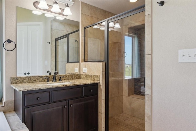 bathroom featuring vanity and a shower with shower door