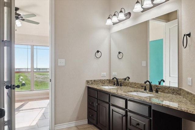 bathroom with ceiling fan, tile patterned flooring, and vanity