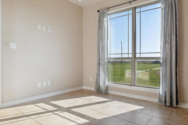 unfurnished room featuring light tile patterned floors and a healthy amount of sunlight