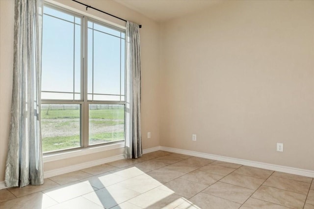 empty room featuring light tile patterned floors and a wealth of natural light