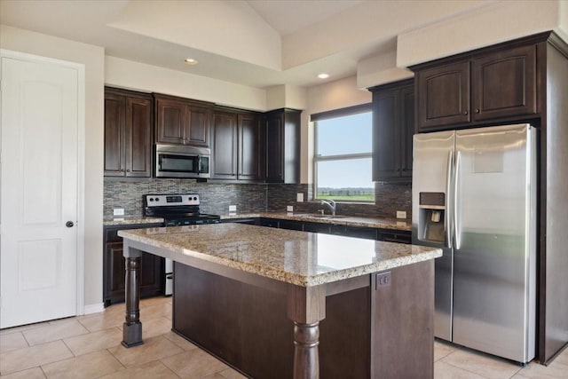 kitchen featuring dark brown cabinets, a center island, sink, and stainless steel appliances