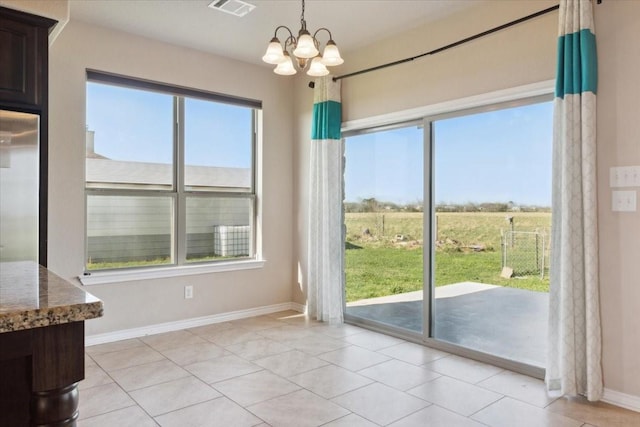 doorway to outside with light tile patterned floors, a rural view, and a notable chandelier