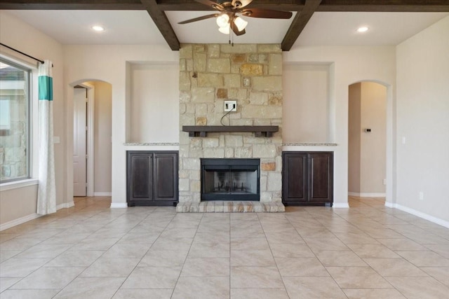 unfurnished living room with beamed ceiling, ceiling fan, and coffered ceiling