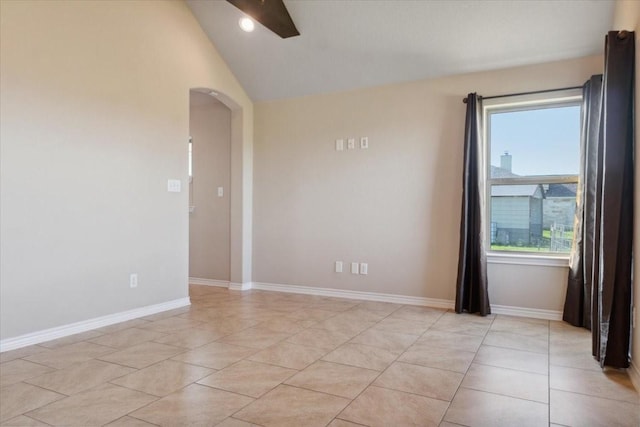 unfurnished room featuring light tile patterned floors and vaulted ceiling