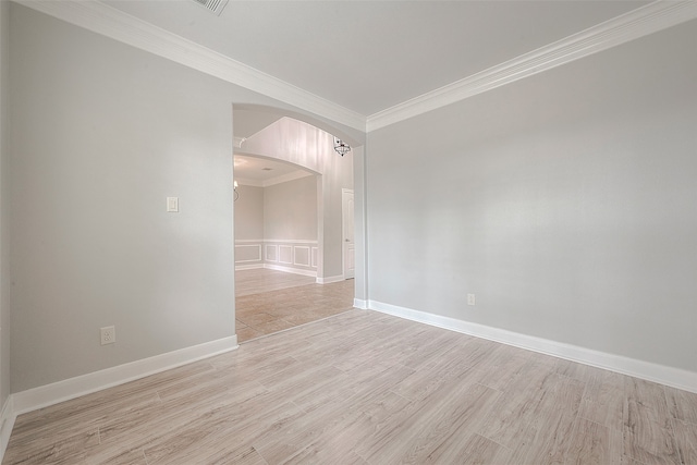 unfurnished room featuring light wood-type flooring and crown molding