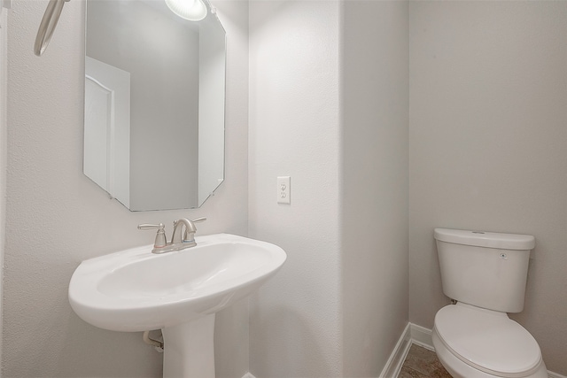 bathroom featuring toilet and tile floors