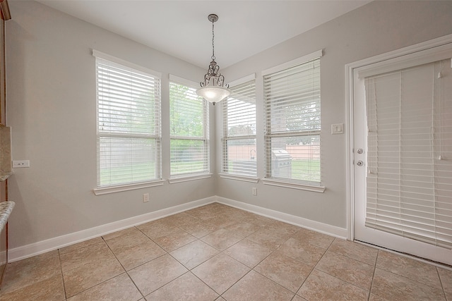 unfurnished dining area with plenty of natural light and light tile floors