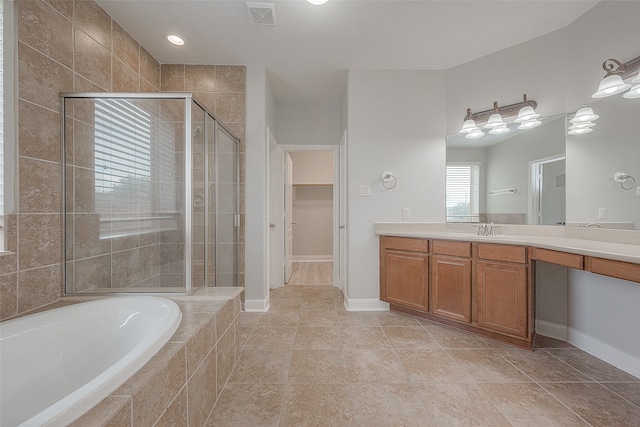 bathroom featuring separate shower and tub, tile floors, and vanity