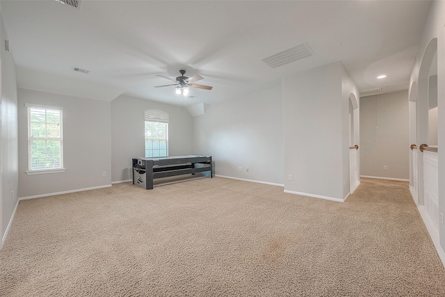 interior space featuring light carpet and ceiling fan