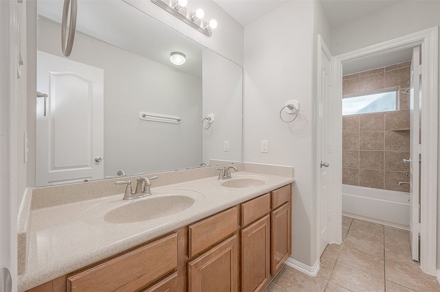 bathroom with large vanity, dual sinks, tiled shower / bath combo, and tile flooring