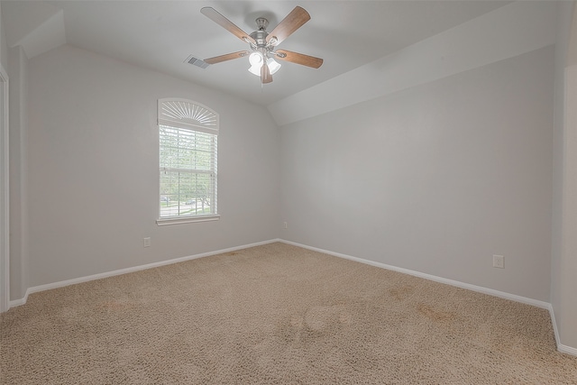 carpeted spare room with ceiling fan and lofted ceiling