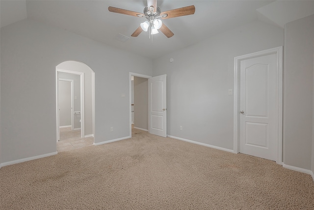 carpeted empty room featuring lofted ceiling and ceiling fan