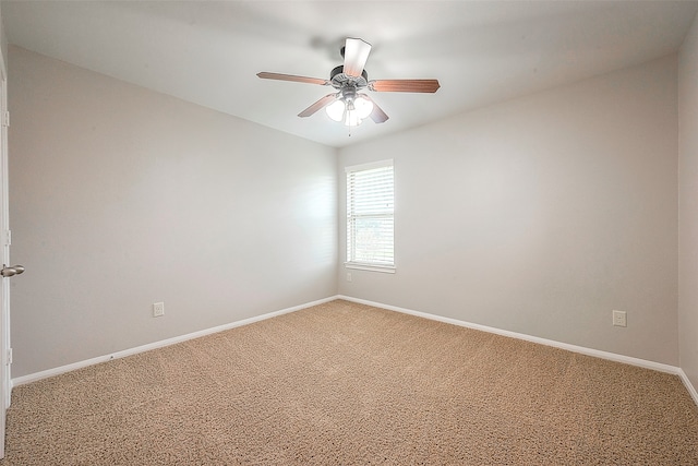 spare room with ceiling fan and light colored carpet