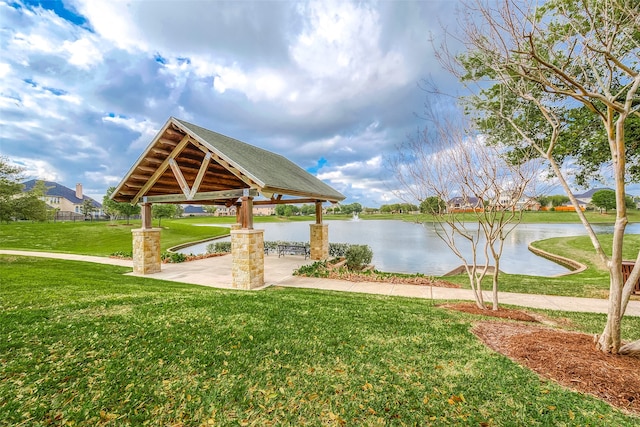 surrounding community featuring a lawn, a gazebo, and a water view