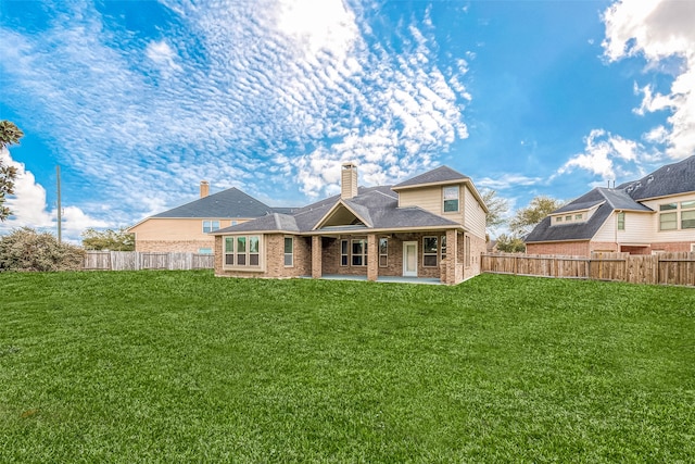 back of property with a lawn and a patio