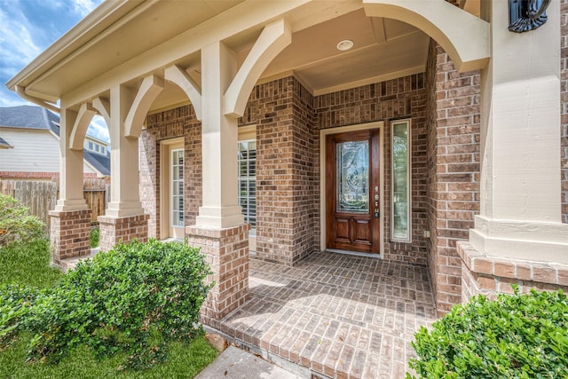 view of exterior entry with a porch