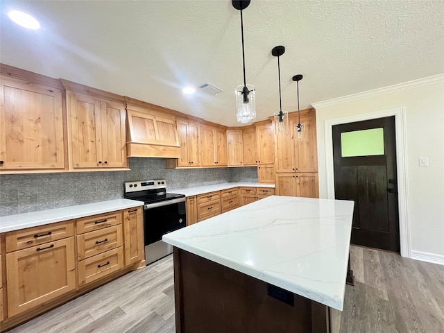 kitchen featuring stainless steel electric range oven, backsplash, light wood-type flooring, custom range hood, and pendant lighting