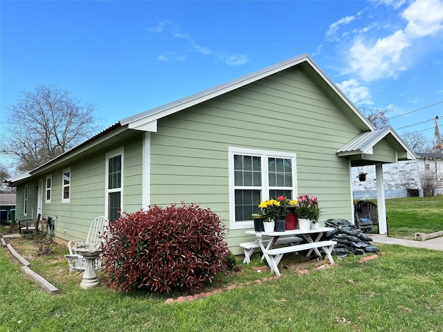 view of side of property with a yard