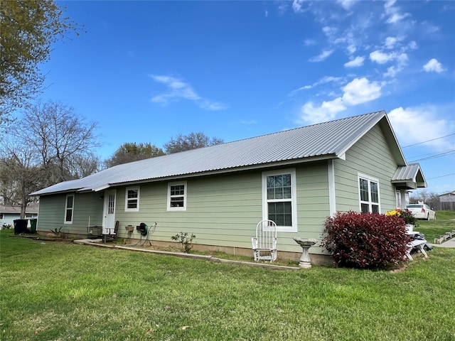 back of property featuring a lawn