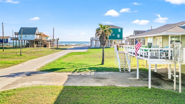 view of play area with a water view and a yard