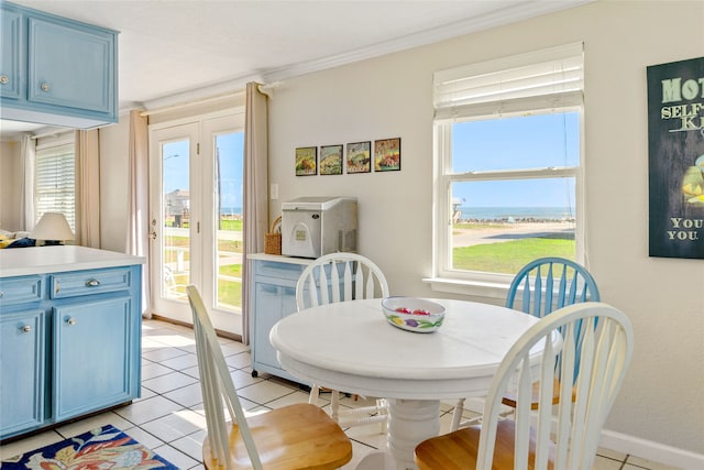 tiled dining space featuring ornamental molding