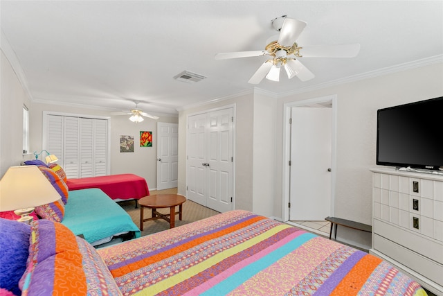 tiled bedroom featuring ceiling fan, a closet, and ornamental molding