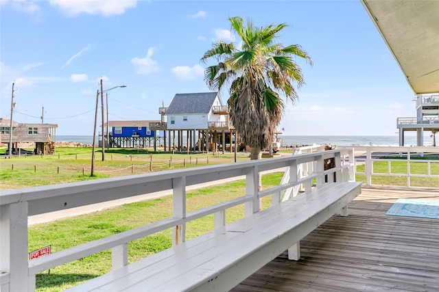 exterior space featuring a yard and a deck with water view