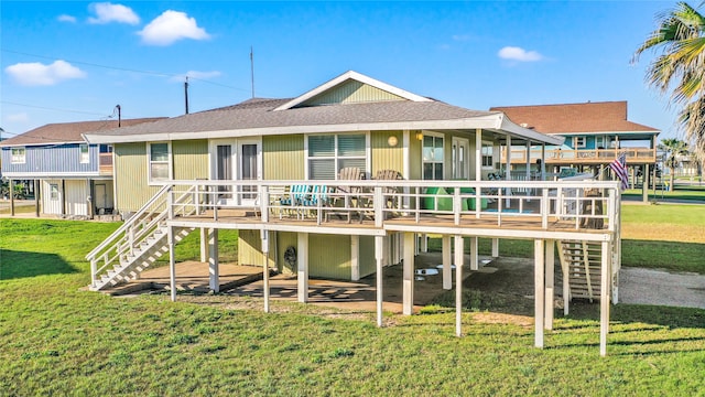 rear view of house featuring a lawn and a wooden deck