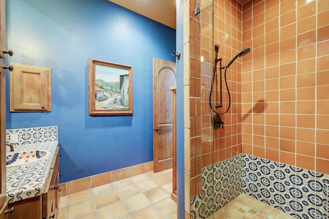 bathroom featuring vanity, tiled shower, and tile patterned floors