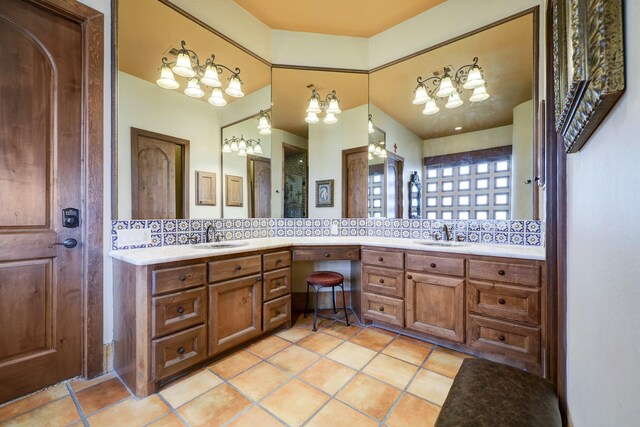 bathroom featuring tile patterned flooring, tasteful backsplash, and vanity