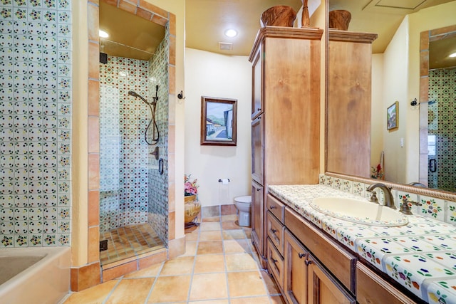 full bathroom featuring toilet, tile patterned floors, plus walk in shower, and vanity