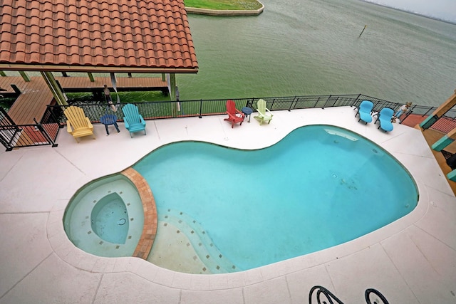 view of pool with a patio area and an in ground hot tub