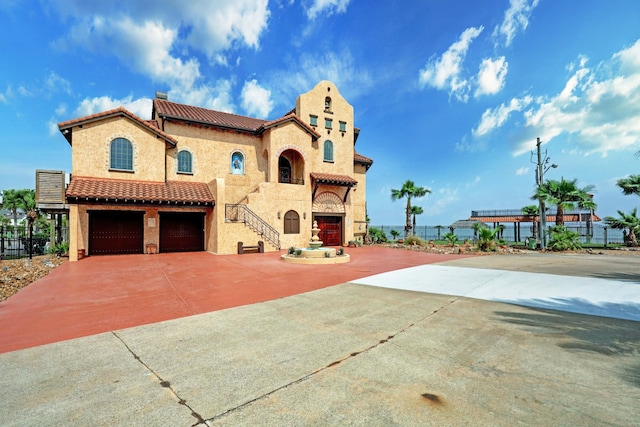 mediterranean / spanish-style house with a garage