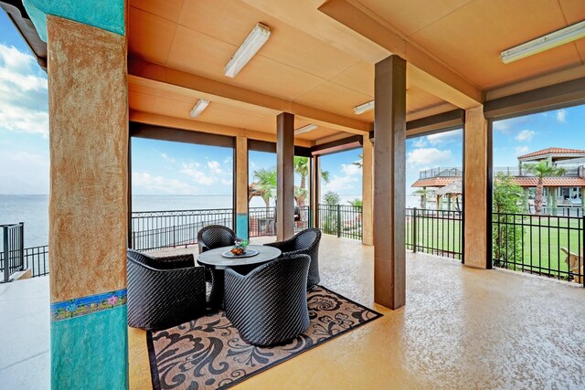 sunroom / solarium featuring a water view