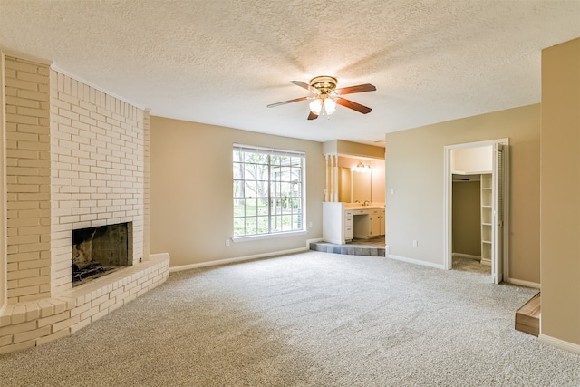 unfurnished living room featuring a textured ceiling and carpet flooring