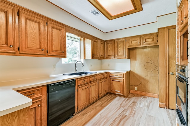 kitchen with sink, black appliances, and light wood-type flooring