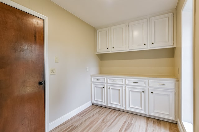 laundry room with light hardwood / wood-style floors