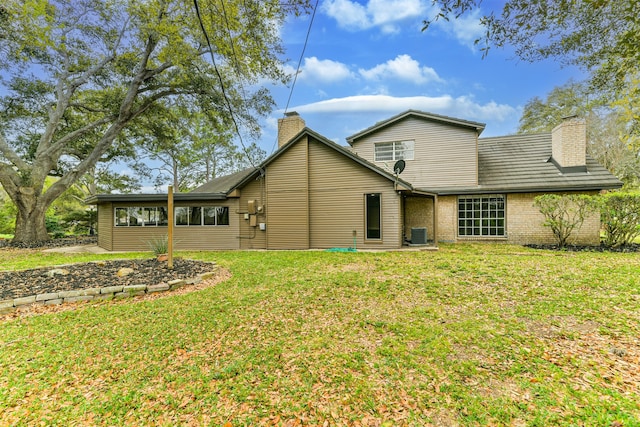 rear view of house featuring a yard and central AC